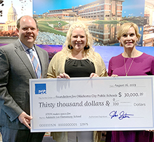 John Semtner presenting FSB's check to Mary Melon from the OKC Public School Foundation and the principal of Adelaide Lee Elementary School